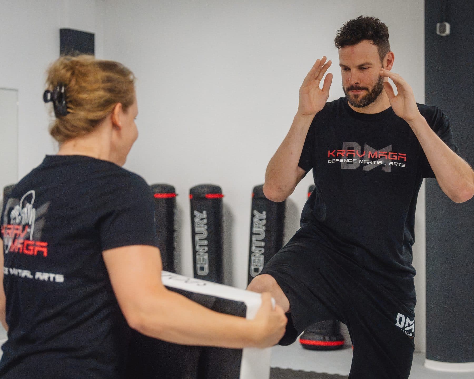 Krav-Maga-Training: Tritt auf das Schlagpolster der Trainingspartnerin